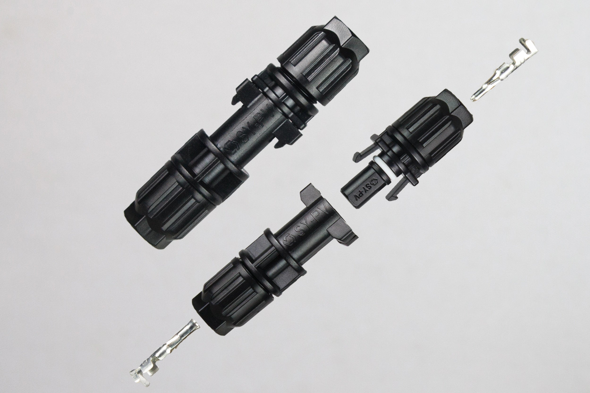 Disassembled PVconnectorpro CC2A miniature solar photovoltaic connector showing internal contacts and waterproof housing for 0.75-2.5mm² cables.